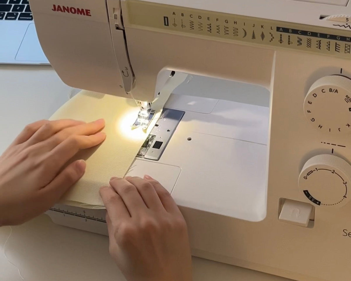 Miranda's hands working with fabric or ceramic components